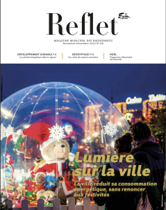 Couverture du magazine, représentant une bulle de Noël géante avec des gens regardant le décor